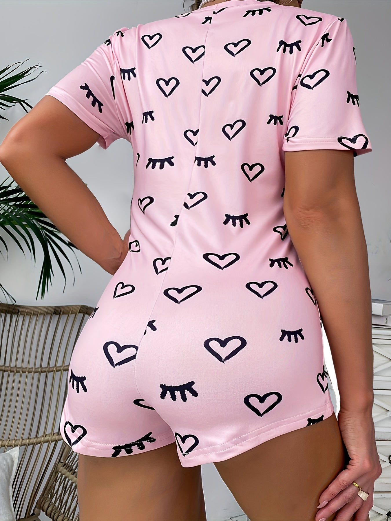Heart & Eyelash Print Button-Up Bodysuit