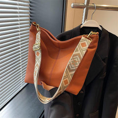 Minimalist Shoulder Bag with Geometric Pattern Strap