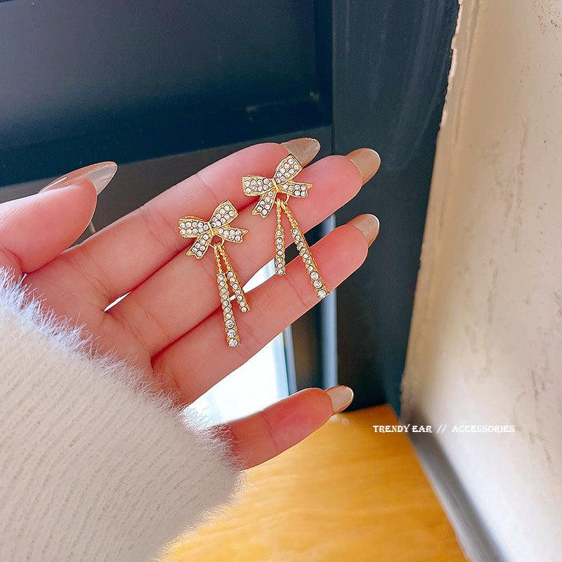 Feminine Celebrity Inspired Long Bow Earrings - Sparkle in Style