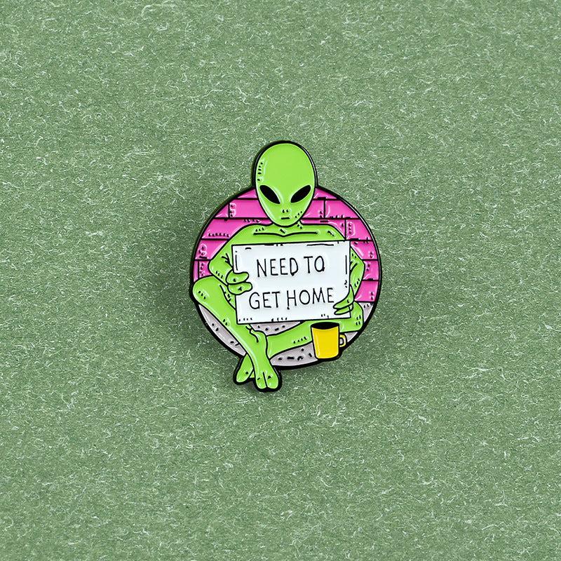 Green Alien Reading Newspaper Brooch