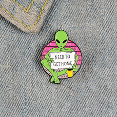 Green Alien Reading Newspaper Brooch